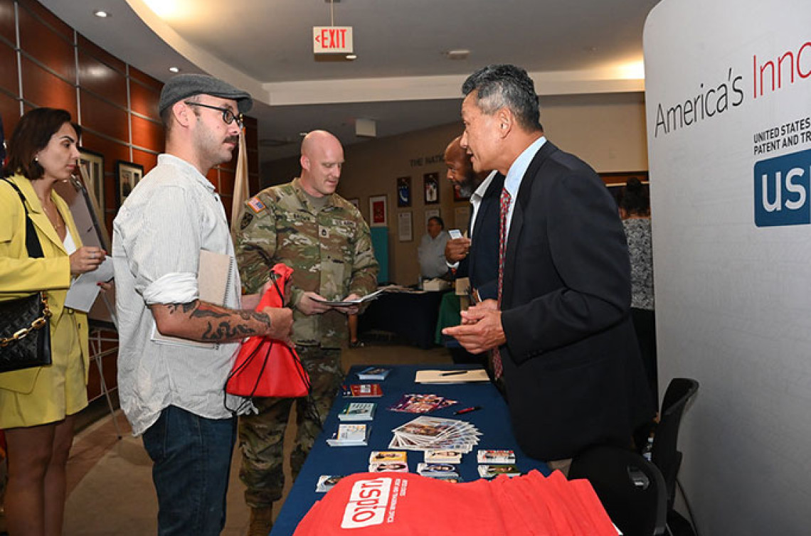 USPTO staff Alford Kindred and Harry Kim share entrepreneurship resources with military personnel and spouses at Hanscom Air Force Base
