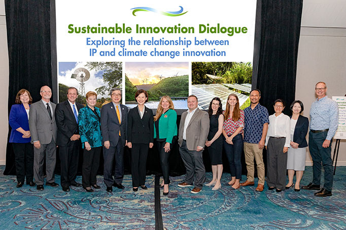 Speakers from the sustainability innovation dialogue at IP5 posing in front of their presentation 