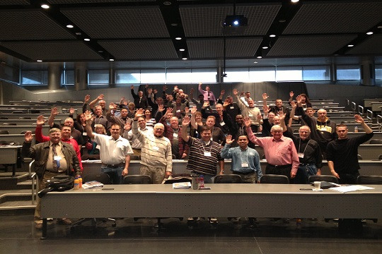 inventors at a USPTO inventors conference all raising their hand