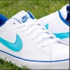 turquoise blue Nike check logo on white sneaker, dark blue word “Nike” and dark blue Nike check under “Nike” wording on tongue of shoe
