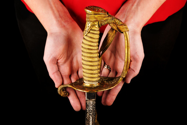 hands holding Sword that belonged to owner's great uncle