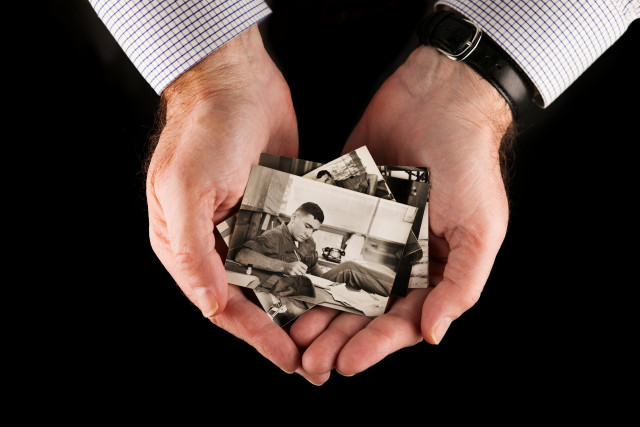 Hands holding Photo of 22-year-old Second Lieutenant John Palafoutas in Vietnam, 1967. 