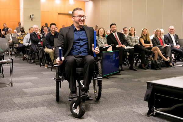 Co-founder of GRIT demonstrates the all-terrain Freedom Chair for the disabled.