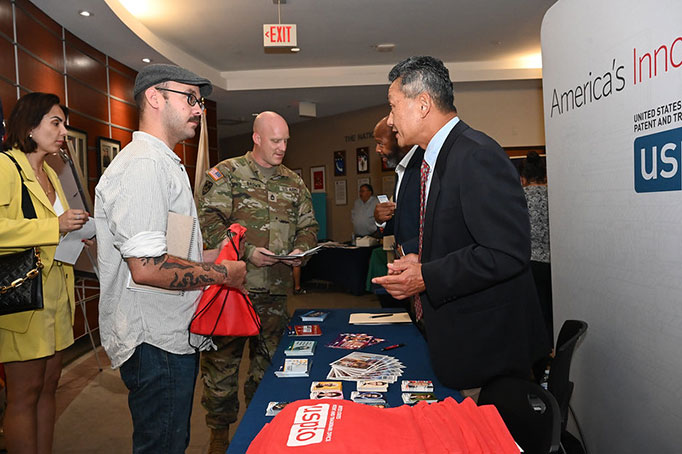 USPTO staff Alford Kindred and Harry Kim share entrepreneurship resources with military personnel and spouses at Hanscom Air Force Base