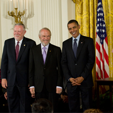 John E. Warnock and Charles M. Geschke stand beside President Barack Obama