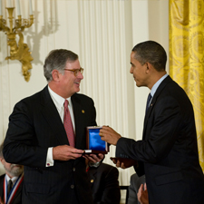 IBM representative receives medal from President Barack Obama