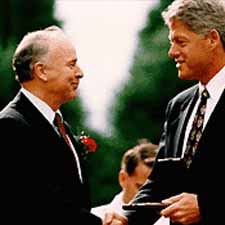 William H. Joyce shakes hands with President Bill Clinton