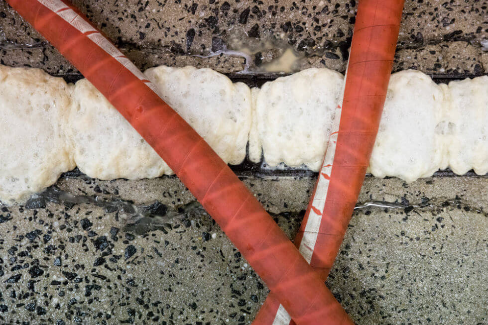 Image:pressurized lines crisscross a drain trench.