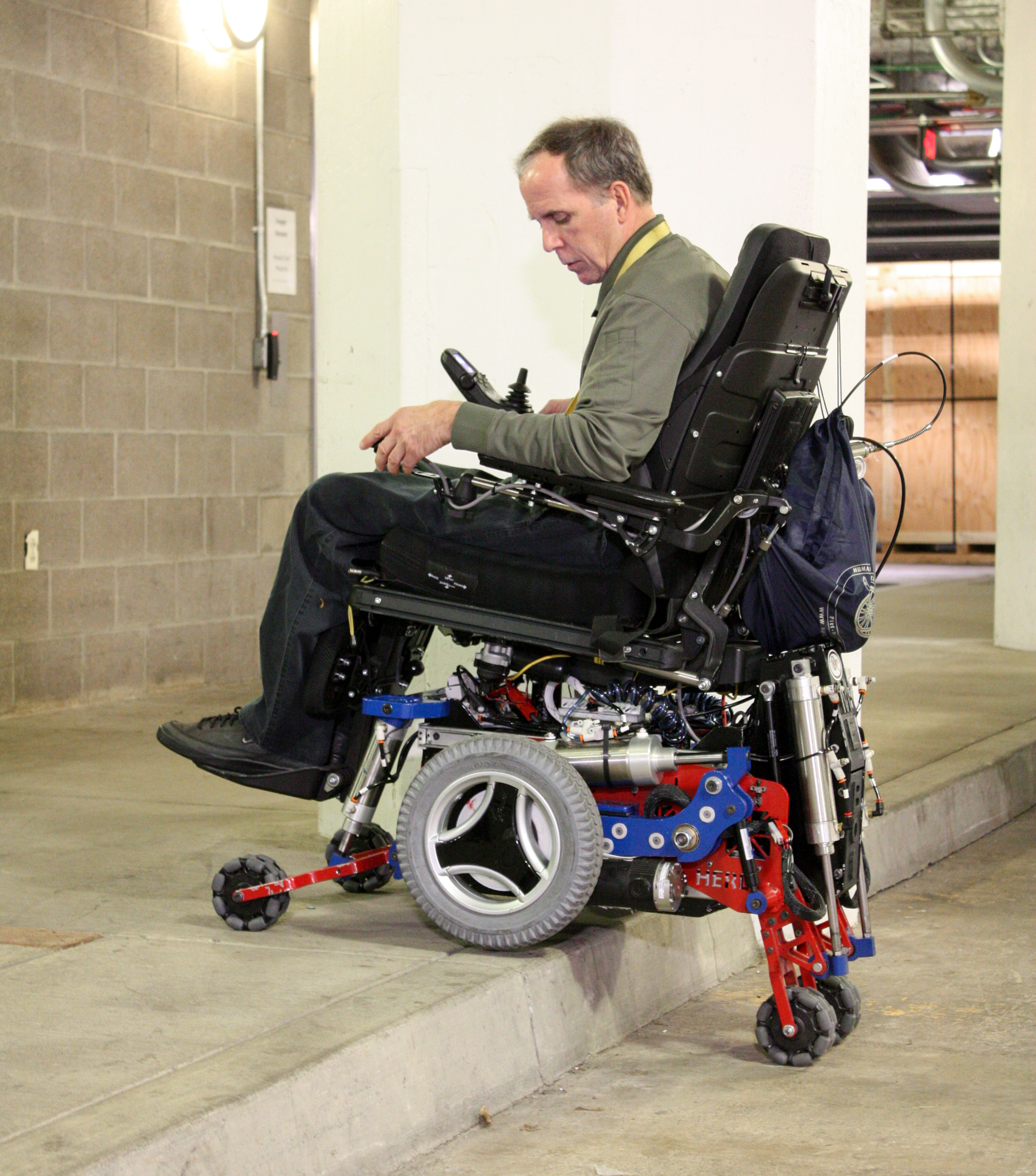 Rory Cooper, who is paralyzed from the waist down, climbing a curb in his MEBot power chair