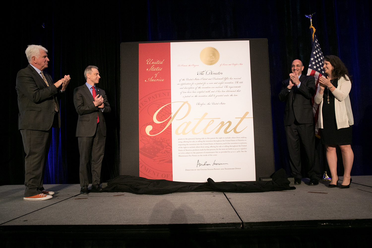 Inventors Susann Keohane and Robert Metcalfe helping USPTO Director Andrei Iancu and Drew Hirshfeld, unveil the new cover design to commemorate the the 10 millionth utility patent at the South by Southwest conference.