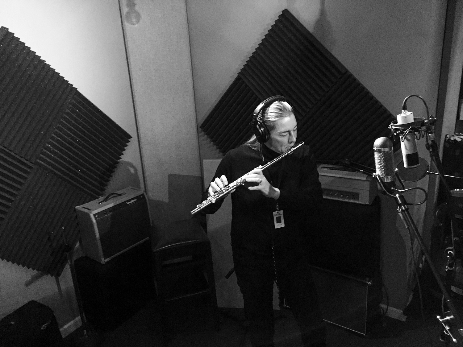 Martine Rothblatt in a professional recording studio playing her flute, black and white.