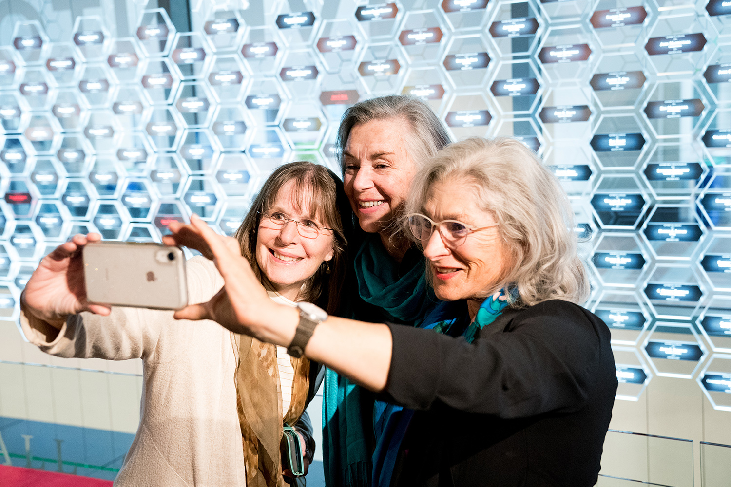 Picture of Polly Smith, Lisa Lindahl, and Hind Miller taking a selfie together.