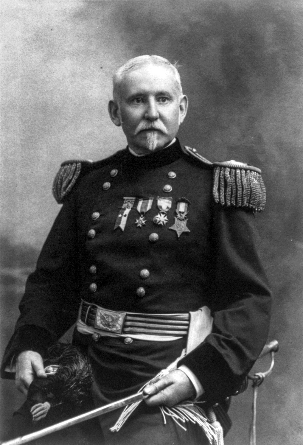A man, George Gillespie, in full military dress and holding a sword, with four medals pinned to his chest.