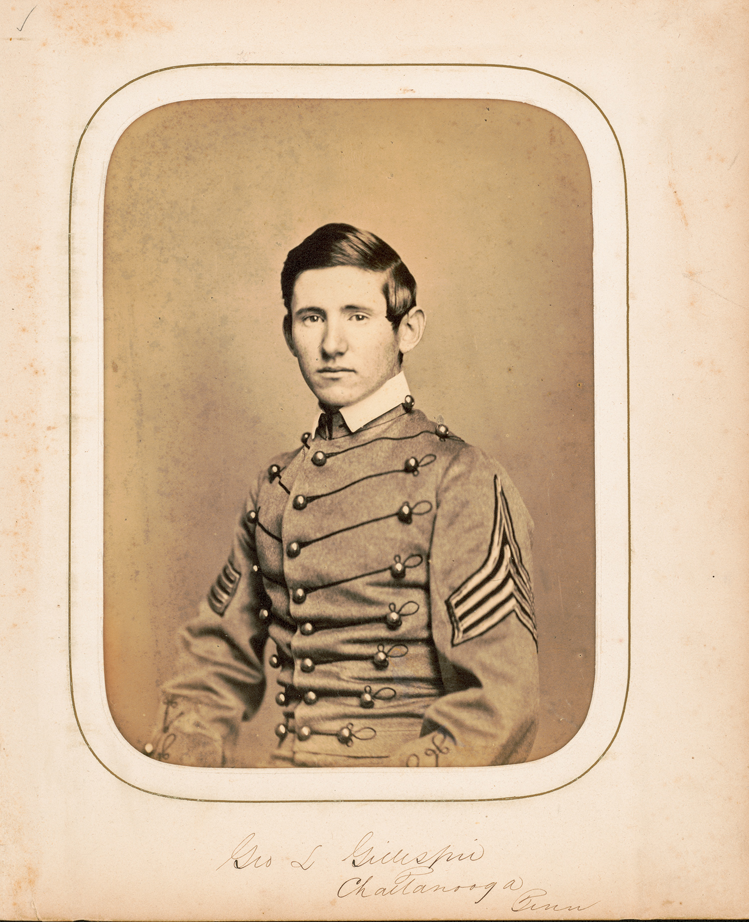 A young man, George Gillespie, in a grey West Point cadet uniform looking directly into the camera