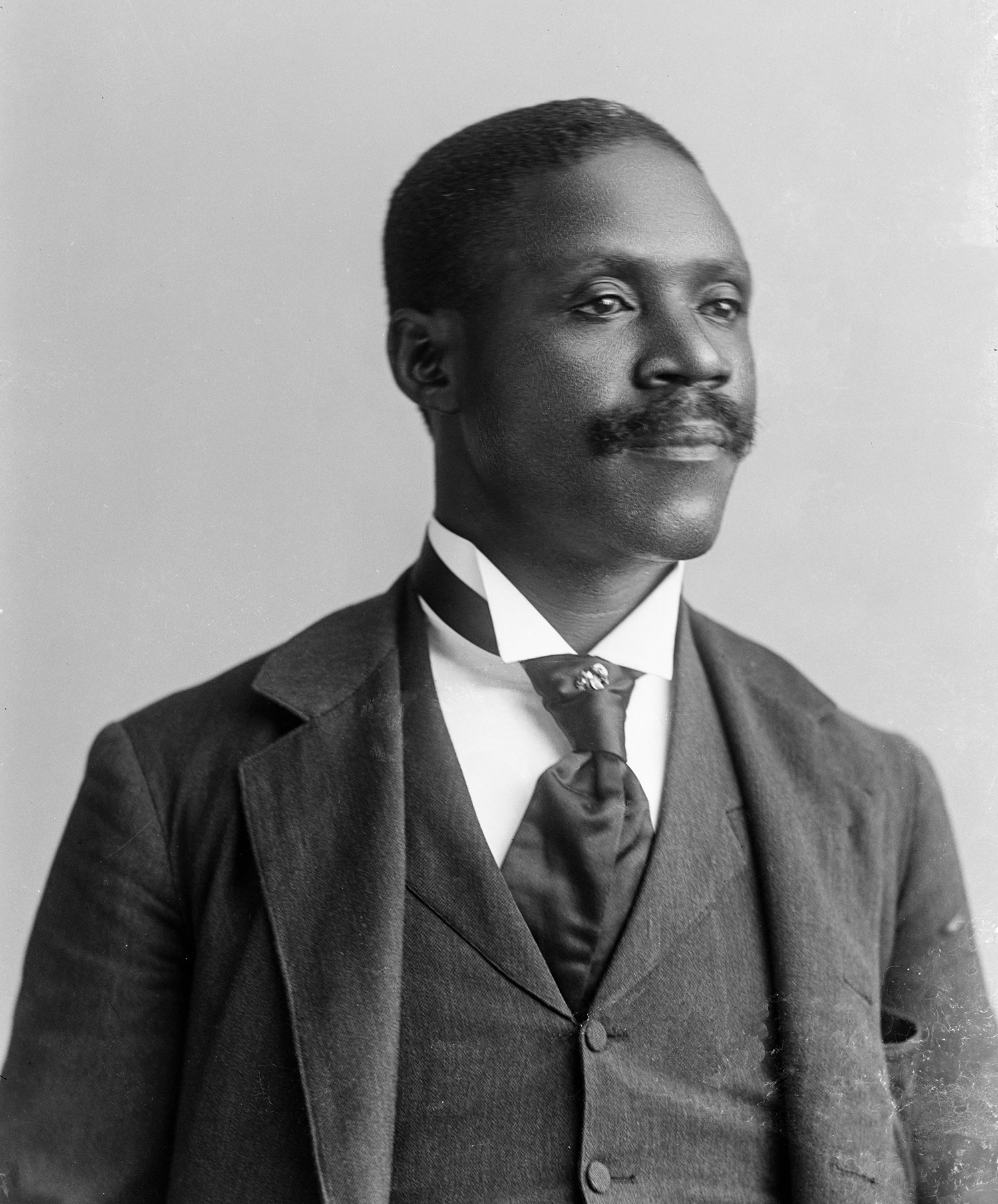 Black and white portrait photo of George Washington Murray, an African American man, wearing a three-piece suit 