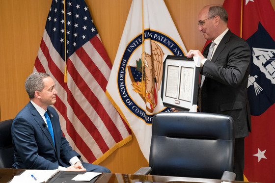 Drew Hirshfeld presents Deputy Secretary of Commerce Don Graves with a copy of his ancestor's patent