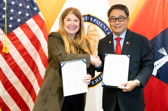 USPTO Director Kathi Vidal and IPOPHL Director General Rowel S. Barba posing with signed agreement.