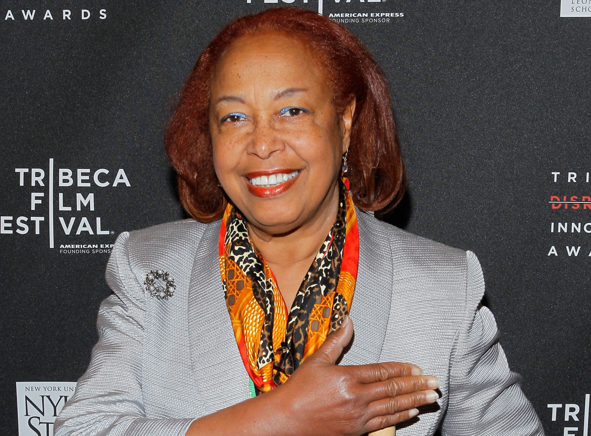 Dr. Patricia Bath stands in front of a Tribeca Film Festival backdrop and smiles into the camera. 