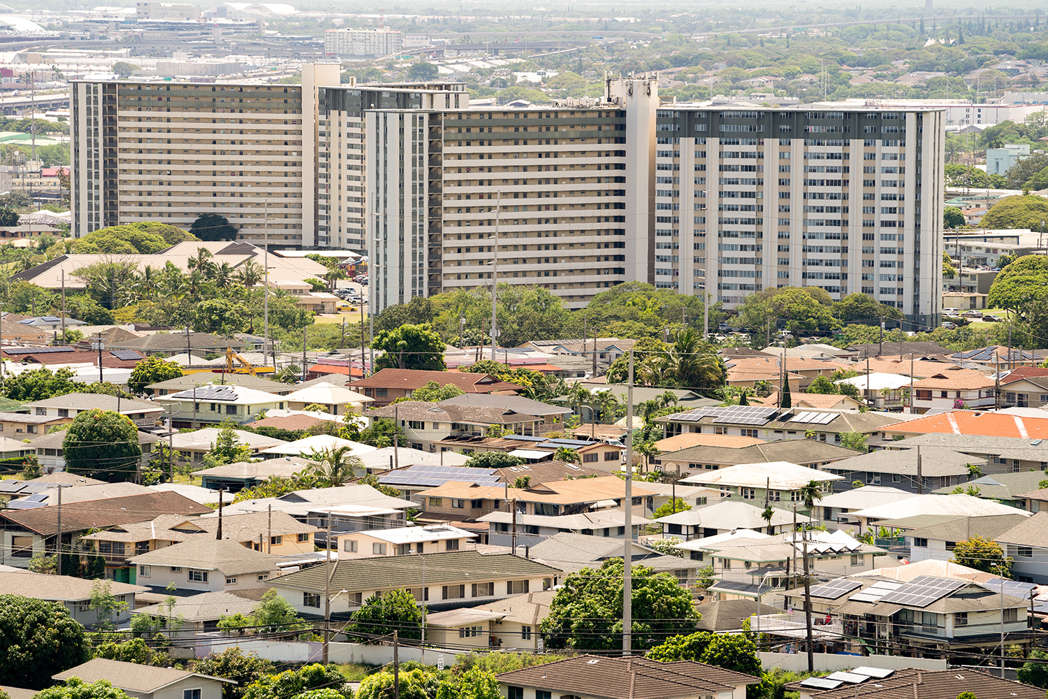 Two high-rise buildings are shown in the background with private homes surrounding them. 