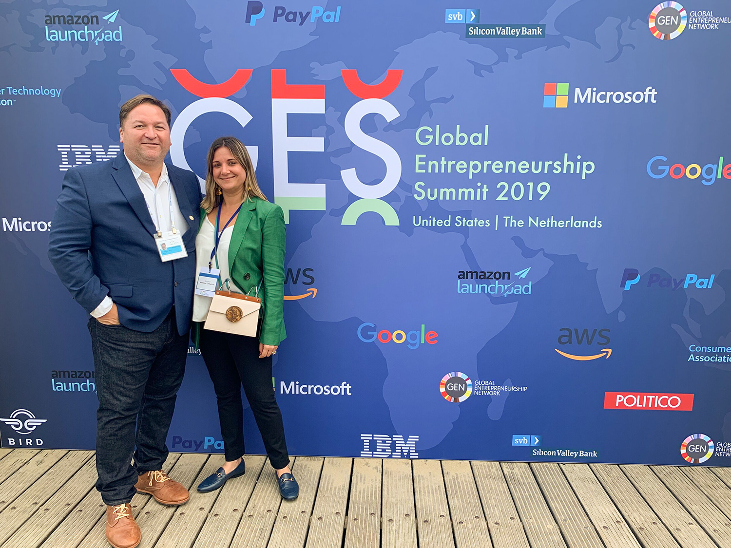 Vanessa Carballido Clerch y Francisco Laboy Colondres, cofundadores de Genmoji, posan frente a un telón de fondo que dice “GES Global Entrepreneurship Summit 2019 United States | Netherlands."