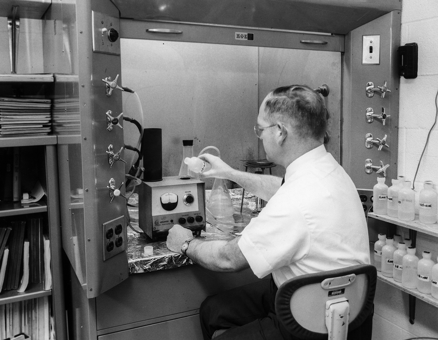 Man conducts testing on a device in a laboratory
