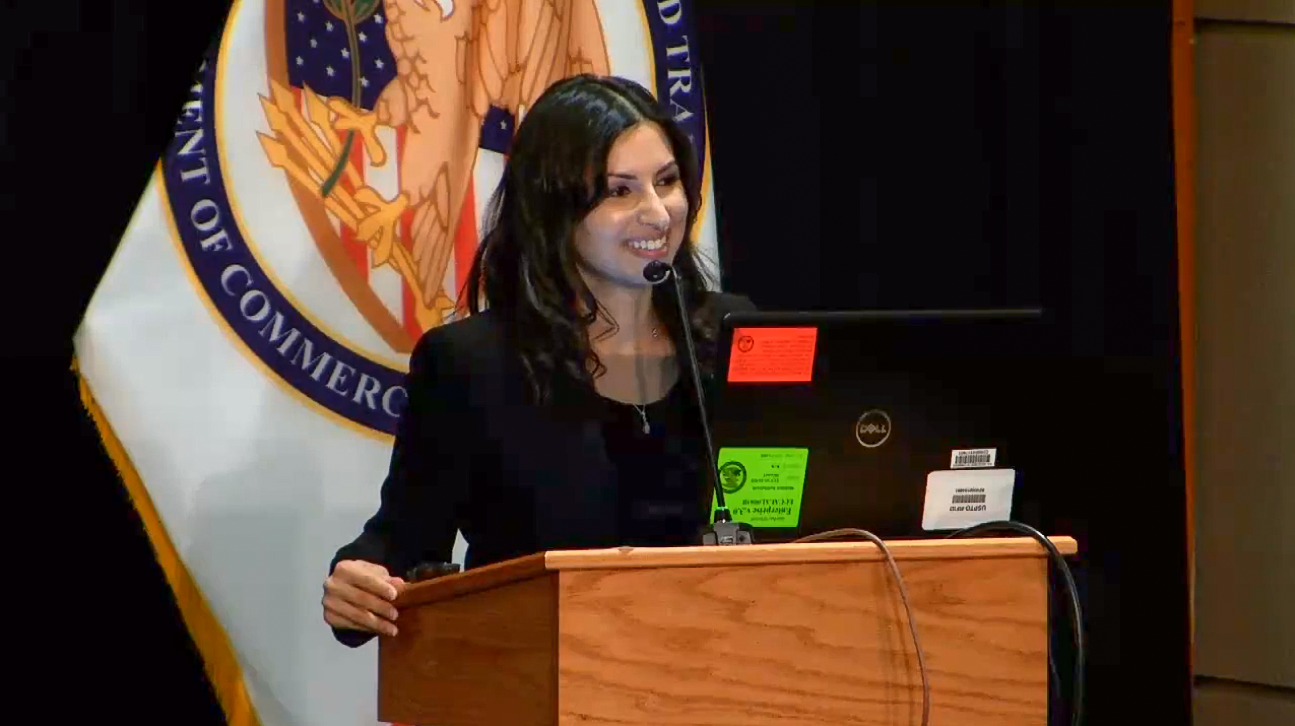 Kavita Shukla speaks at a podium at the United States Patent and Trademark Office 
