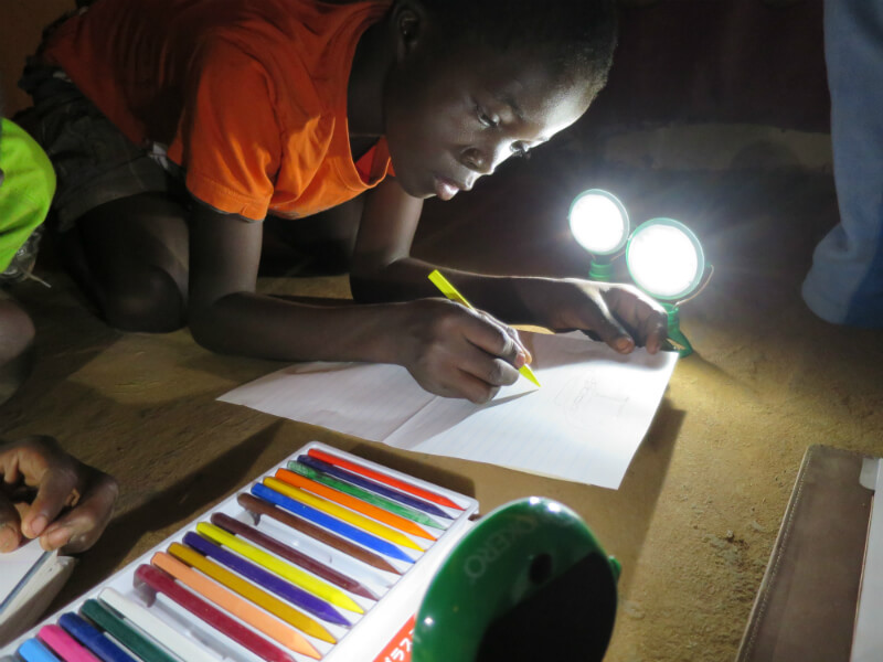 Image: Student studying at night using solar lights