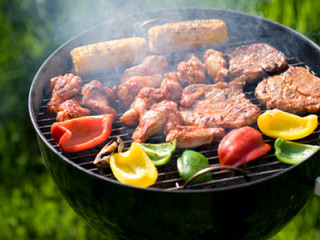 Grill filled with a variety of summer foods
