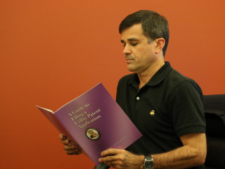 Man reading the Guide to Filing a Utility Patent Application