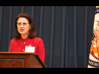 Dr. Janine Jagger speaking at a podium