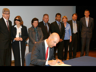 USPTO Director David Kappos signs patent number 8 million at a signing ceremony hosted by the USPTO at the Smithsonian American Art Museum