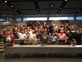 inventors at a USPTO inventors conference all raising their hand