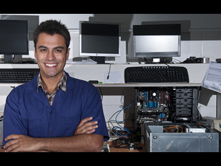 Man standing proudly infront of computers
