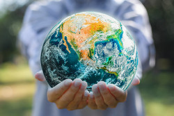 Close up of a person's holding an earth globe