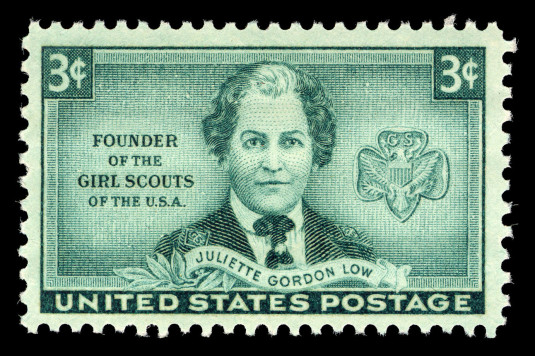 United States postage stamp showing the trefoil badge and Juliette Gordon Low in a Girl Scout uniform. 