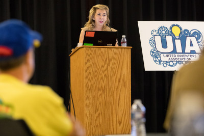 Deputy Director Laura Peter stands at a podium and gives a speech at the UIA Leadership Day event