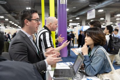 USPTO employee speaking to a member of the public at a help booth during 2020 CES.