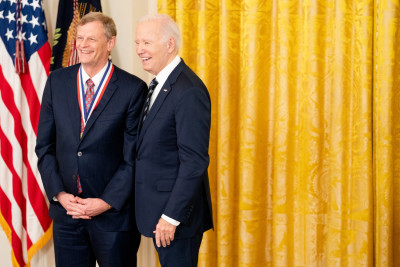 John Cioffi wearing a dark suit smiles with President Biden right after receiving the National Medal of Technology and Innovation.