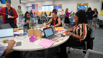 A group of educators at a round table working on an invention project at the USPTO’s National Summer Teacher Institute