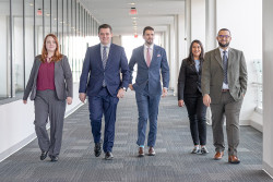 PTAB FY23 judicial law clerks Alexis R., Chris K., Will N., Erin H., and Haytham S. walking together.
