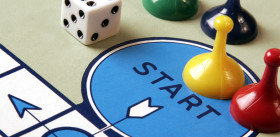 Getting into the Game: Q&A with the Experts Board game pieces and dice arranged on a game board
