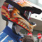 Photo of a racecar driver in front of the Mattel booth.